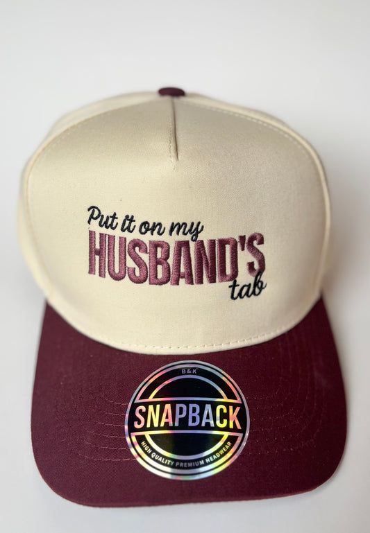 "Put it on my husband's tab" Trucker Hat